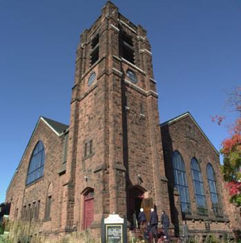 The square bell tower of First Moncton United Baptist Church is one of the striking features of this brown sandstone structure.; First Moncton United Baptist Church