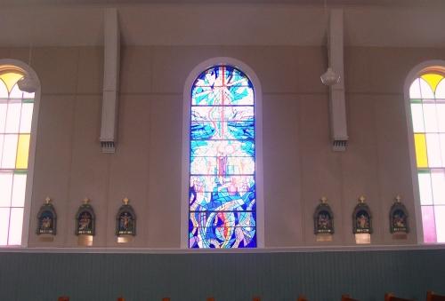 Interior view of recent stained glass flanked by original stained glass in St. Charles Borromeo Church, Fermeuse, NL. Photo taken April 2006.; 2006 HFNL/Andrea O'Brien
