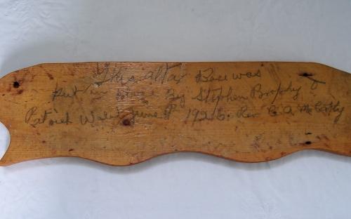 Piece of wood retrieved during renovations that documents construction of altar in St. Charles Borromeo Church, Fermeuse, NL. Photo taken April 2006.; 2006 HFNL/Andrea O'Brien