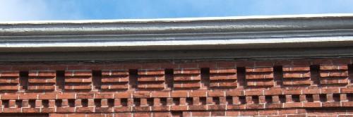 This image provides a view of the cornice ornamented by brick corbel bands, 2005.; City of Saint John