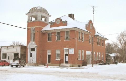 View of the front elevation of the Craik Town Hall featuring the brickwork and tower.; Saskatchewan Architectural Heritage Society, Frank Kovermaker, 2005.