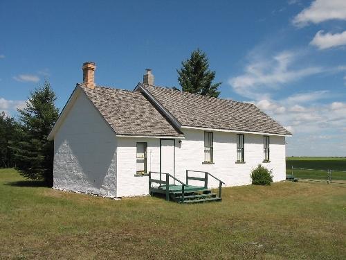 Side elevation with landcaped grounds and prairiescape in background, 2005; Kyle Zelmer, 2005