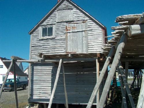 Exterior view of gable end of net store and part of fish flake, Samuel Abbott property, Bonavista, NL, circa 2006; Bill Abbott/HFNL 2006