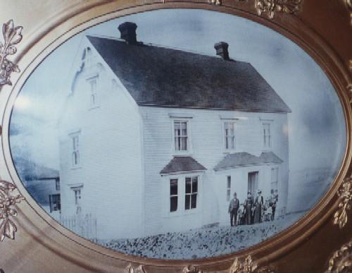 Historic family portrait including a front and side exterior view of Henry Tremblett House in Bonavista, NL, circa 1895; HFNL 1996