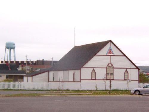 Front and side view of SUF Lodge #9 with water tower in the background, Bonavista, NL, 2006/06/14; L Maynard/HFNL 2006