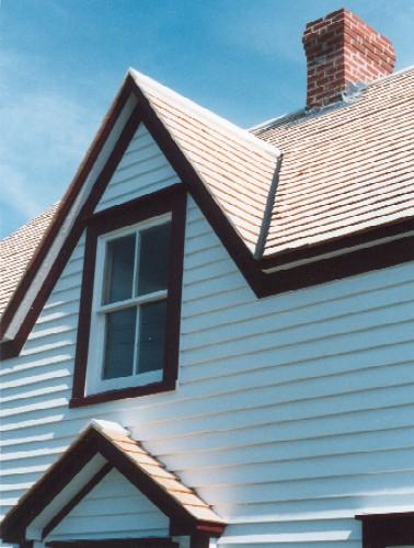 Detail of central peaked dormer just above the main entrance.  This is a typical feature in the Bonavista area.; HFNL 2004