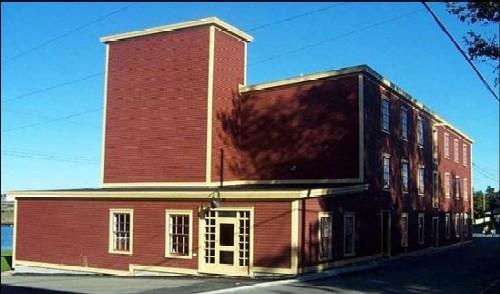 Exterior view looking east of the left and front facades of the Fishermen's Protective Union Factory/Advocate Building, Port Union, NL.; Sir William Coaker Heritage Foundation, 2004