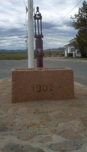 Front view of pump and trough; Norma Stewart