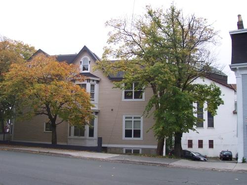 North facade of Emmanuel House bordered by Bannerman and Cochrane Streets.  The Cochrane Street United Church can be seen directly behind the house, on the right (white building with red/brown squares, triple lancet windows). ; HFNL/ Deborah O'Rielly 2006.