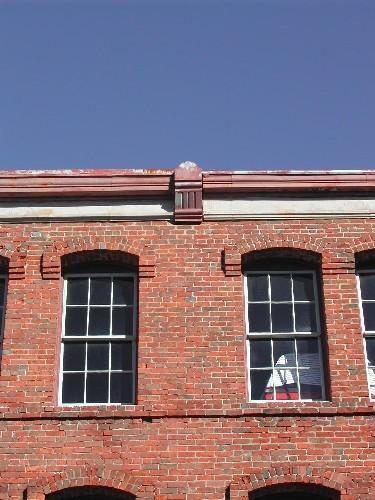 This photograph shows the cornice and two upper storey windows, 2004; City of Saint John
