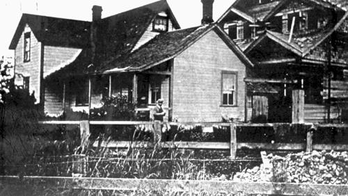 The 1st and 2nd Parmiter Houses, while 2nd (at right) was under construction and before the 1st was relocated, circa 1919; Delta Museum and Archives, #1970-1-491