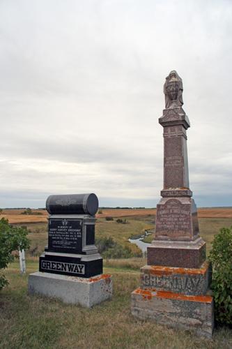 View, from the east, of the Thomas Greenway Cemetery, Crystal City, 2006. These stones mark the graves of two sons of Thomas Greenway, Harry and Thomas A.; Historic Resources Branch, Manitoba Culture, Heritage and Tourism, 2006