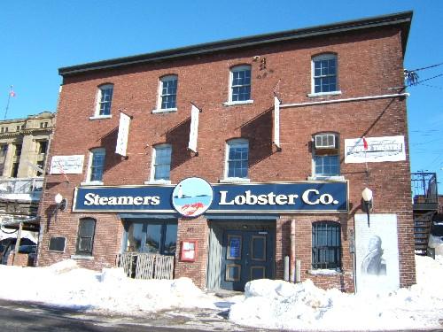 Andrew Malcolm's Warehouse - This photograph shows the contextual view of the building on the corner of Water Street and Duke Street, 2005; City of Saint John