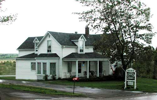 Sylvain Gaudet House - Northwest view of the house - Front façade and north elevations of the main body of the house, as well as the east wing of the house and the gable dormers.; Gérard LeBlanc