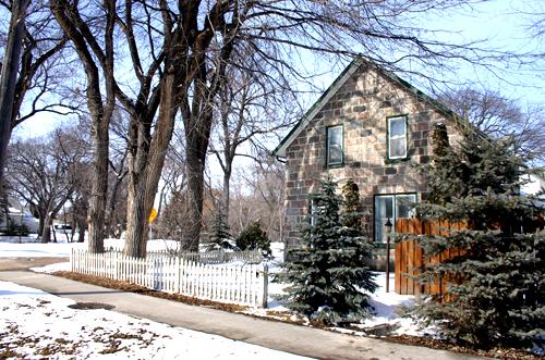 View looking across wooded lot, of the McElroy House, Morden, 2005; Historic Resources Branch, Manitoba Culture, Heritage and Tourism, 2005