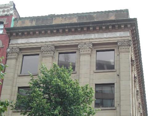 This photograph shows the upper storey windows, corinthian columns and cornice, 2004; City of Saint John