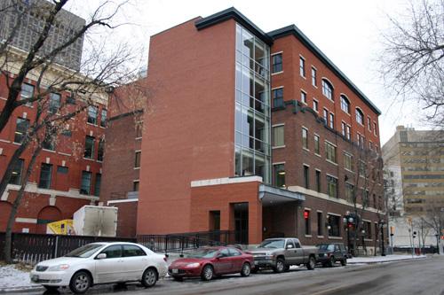 Secondary elevations (with original three storey section distinguished from recent two storey addition by brick colour and fenestration and also showing lobby addition), from the northeast, of the Northern Electric Building, Winnipeg, 2007; Historic Resources Branch, Manitoba Culture, Heritage and Tourism, 2007