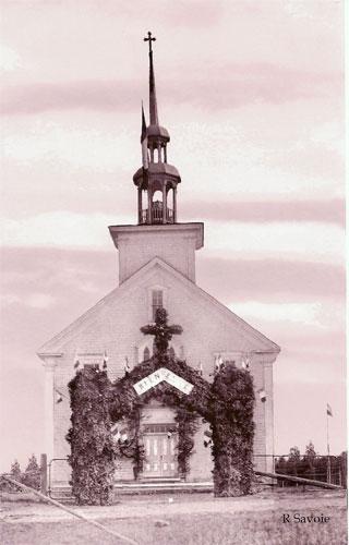 The second church on its former site at the Higho de Cocagne Institutional Centre. The second church in Saint-Antoine is decorated for a religious celebration in 1913; R, Savoie/Valmond Léger Collection