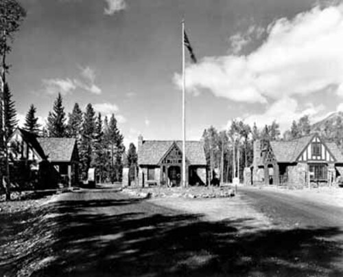 View of the East Gate Registration Buildings, with Building 1 to the left, showing the Rustic style with Tudor Revival details, 1985.; Parks Canada | Parcs Canada, 1985.