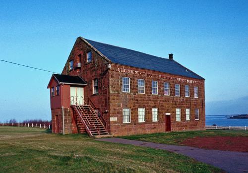 General view of Farmers' Bank of Rustico showing the regularly coursed sandstone construction.; Parks Canada Agency / Agence Parcs Canada.