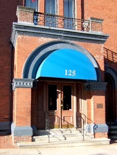 This image shows the brick and stone portico crowned with square pilasters, 2005; City of Saint John