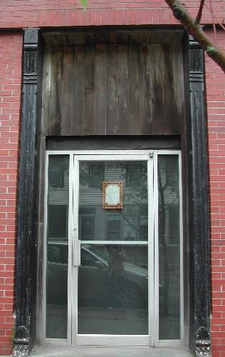 This photograph shows the wooden pilasters and brackets on either side of the north entryway, 2005. ; City of Saint John, 2005