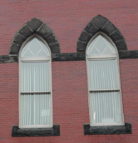 This photograph shows the Gothic arch windows on the third storey of the façade, 2005.; City of Saint John