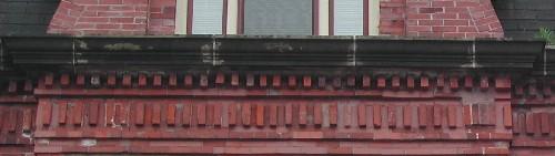This photograph shows the cornice ornamented with brick dentils, 2005.; City of Saint John