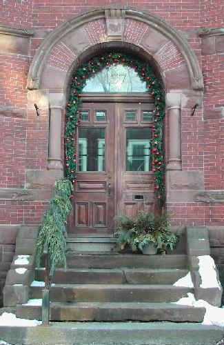 This image shows the Roman arched entry including a brick and stone entablature, 2006.; City of Saint John
