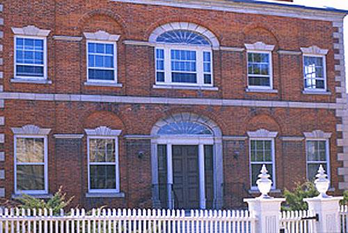 Detail view of McMartin House National Historic Site of Canada showing the Adamesque or Federal style detailing, its use of relieving arches over the window bays, pilasters, and ornate window headers, 1995.; Parks Canada Agency / Agence Parcs Canada, J. Butterill, 1995.