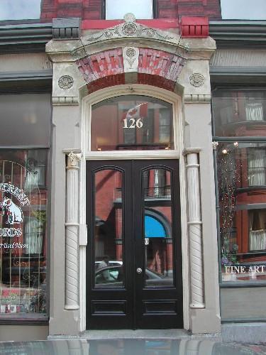 This image provides a view of the central entry, with an elaborate entablature supported by stone pilasters, 2005.; City of Saint John