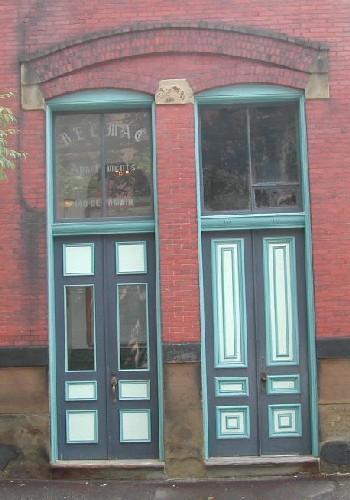 This image provides a view of the matching, dual entries with paired wood doors, 2005.; City of Saint John
