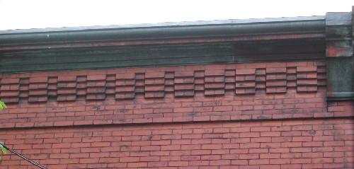 This image provides a view of the projected cornice ornamented with brick corbel bands, 2005.; City of Saint John