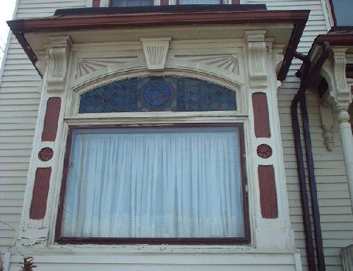 Stained glass and carved mullions are features of the front bay window.; City of Windsor, Nancy Morand
