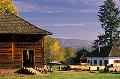 General view of the Fort Langley National Historic Site of Canada showing viewplanes from the palisades to the Fraser River and McMillan Island, to the east, looking upriver towards the site of the earlier fort, and to the countryside and west, 1988.; Parks Canada Agency / Agence Parcs Canada, A. Cornellier, 1988.