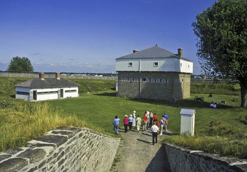 General view of Fort Wellington showing design as three sections including a squat lower storey, an overhanging upper storey, and a pyramidal roof, 2006.; Parks Canada Agency / Agence Parcs Canada, Brian Morin, 2006.