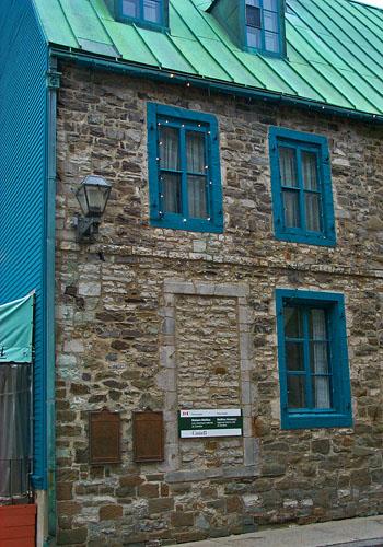 Detail view of Maillou House showing the rough-cut stone construction with dressed stone trim.; Parks Canada Agency / Agence Parcs Canada.