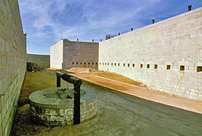 General view of the Fort Henry dry ditch showing its generous scale and substantial stone construction materials, 1994.; Parks Canada Agency/Agence Parcs Canada, J. Butterill, 1994.