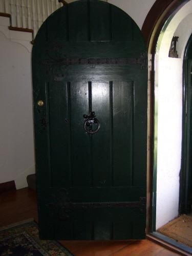 This photograph shows the main entrance door with antique hinges, locks, and door knocker, 2007; Town of St. Andrews