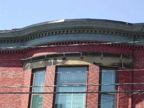 This photograph shows the curved cornice with its dentils and fascia, 2005; City of Saint John