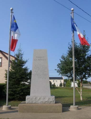 Rhombus-shaped inscribed stele flanked on either side by flagpoles; Fidèle Thériault