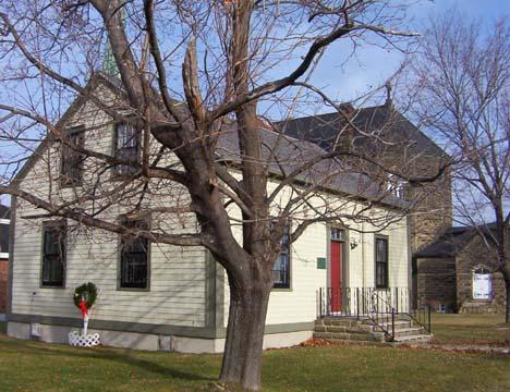 Oblique view of St. Michael's Museum with St. Michael's Basilica in the background, 2005.; City of Miramichi