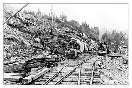 C.E. Fish sandstone quarry, French Fort Cove, circa 1890's. This image shows railway tracks, workers and a steam powered crane; Provinical Archives of New Brunswick - Ole Larsen Collection, P6-67