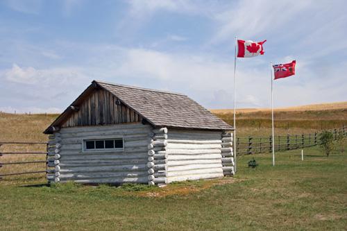 Site view, from the southwest, of the Boundary Commission Trail - Turtlehead Creek Crossing, showing the recreated log building recalling the old Land Titles Office that once stood nearby, Deloraine area, 2006; Historic Resources Branch, Manitoba Culture, Heritage, Tourism and Sport, 2006