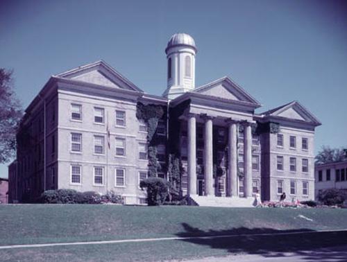 Historic view of the main (south) façade showing the central block, wings, and cupola – c. 1958; Archives of Ontario, 2005