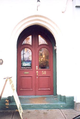 View of the main entrance on the main façade showing gothic arch glass panels – November 2001; OHT, 2001