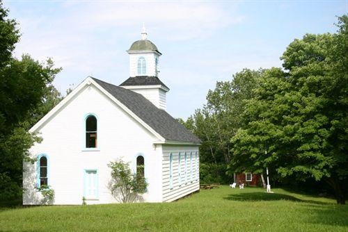 Rear elevation of St. Anne's Mission Church and Glebe House in background, Indian Island, Nova Scotia, 2005.; Javenny Francis 2005.