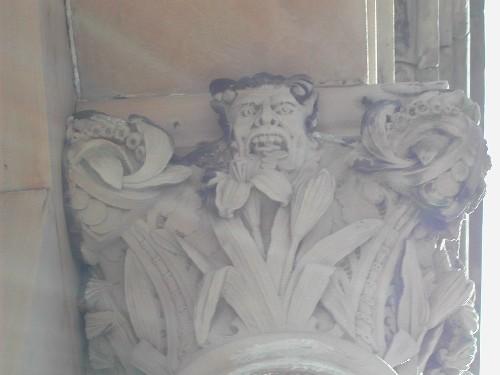 This photograph shows a capital with a gargoyle spitting out coins, 2005; City of Saint John
