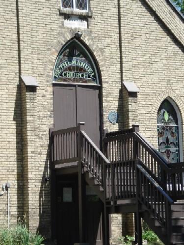 Of note are the arched gothic windows that flank the entrance and gabled roofline.; Kendra Green, 2007.