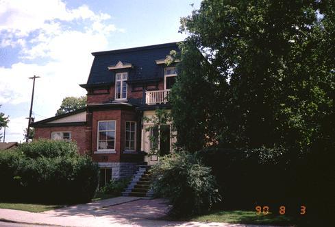 Charming mid-1870s home features original porch with panelled doors, decorated dormer windows above; City of Ottawa 2005